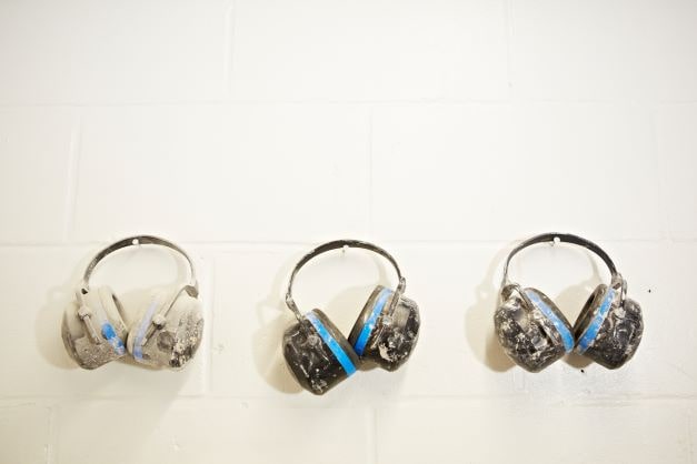 Image for blog post 'High demand for skilled tradespeople continues' shows three pairs of ear defenders hanging on a wall.