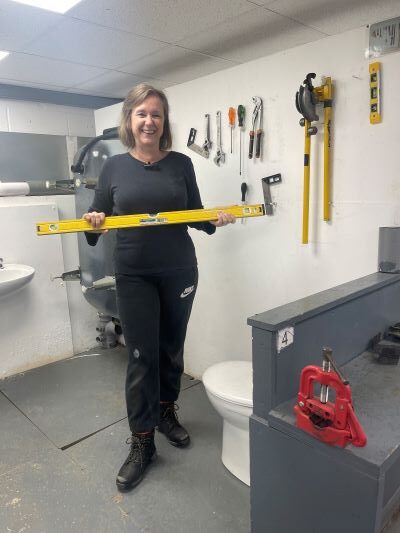 Suzanne Smith standing in the plumbing bay at Able Skills